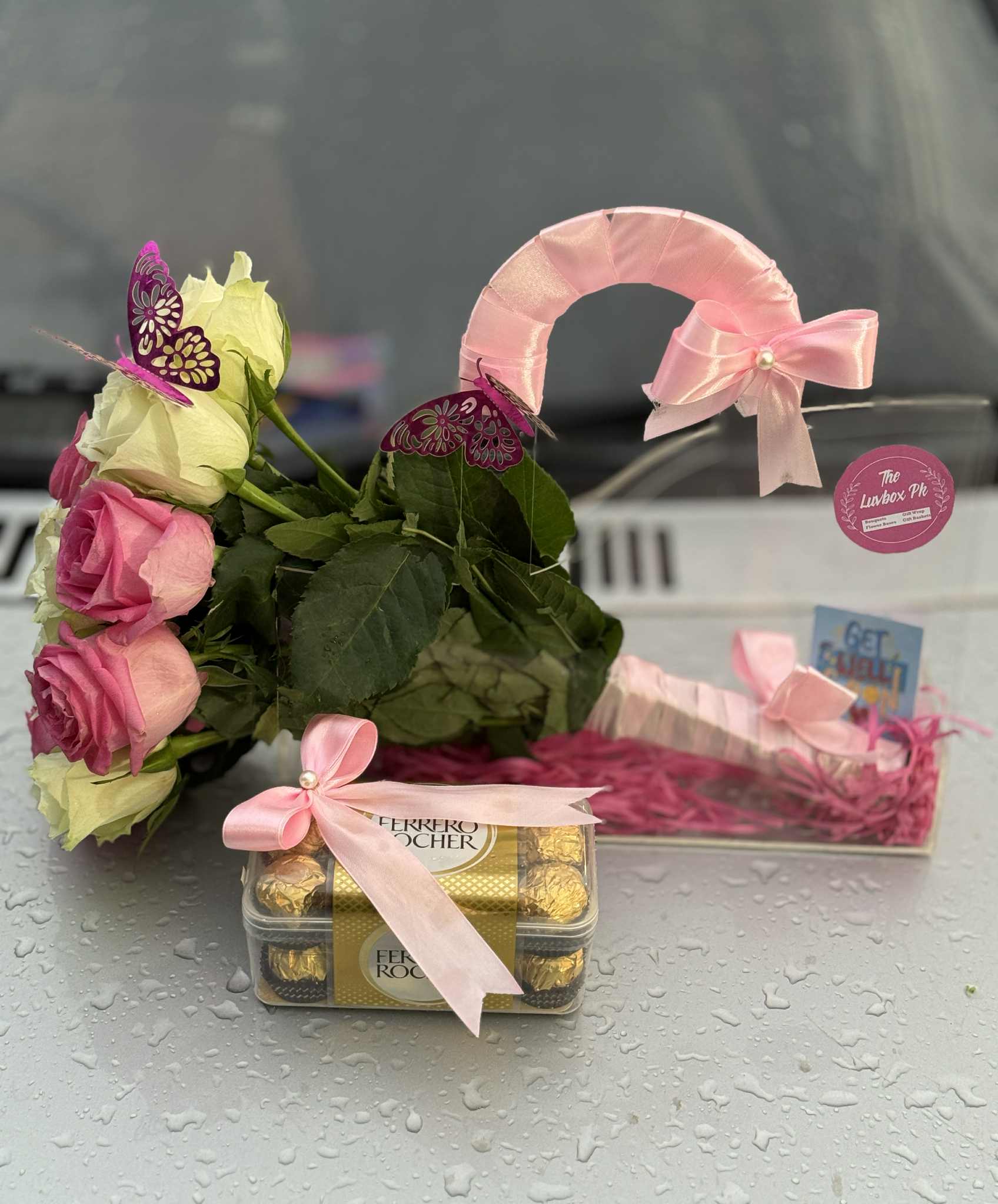Luxury acrylic bag with long stem pink and white roses paired with Ferrero Rocher chocolates – perfect gift in Islamabad, Pakistan.