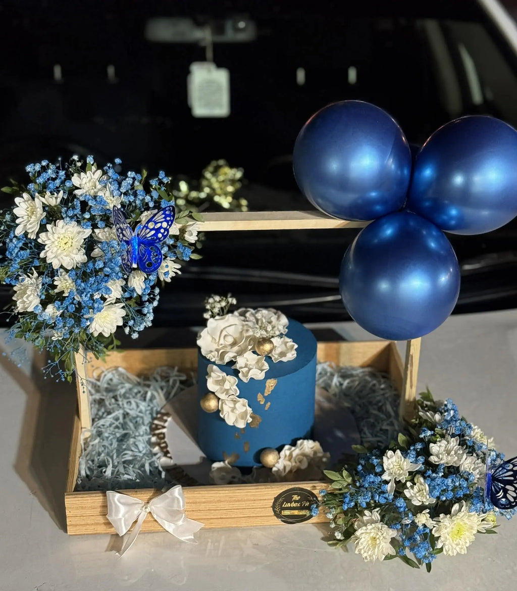 3 lbs premium cake placed in a wooden tray basket with fresh floral decoration.