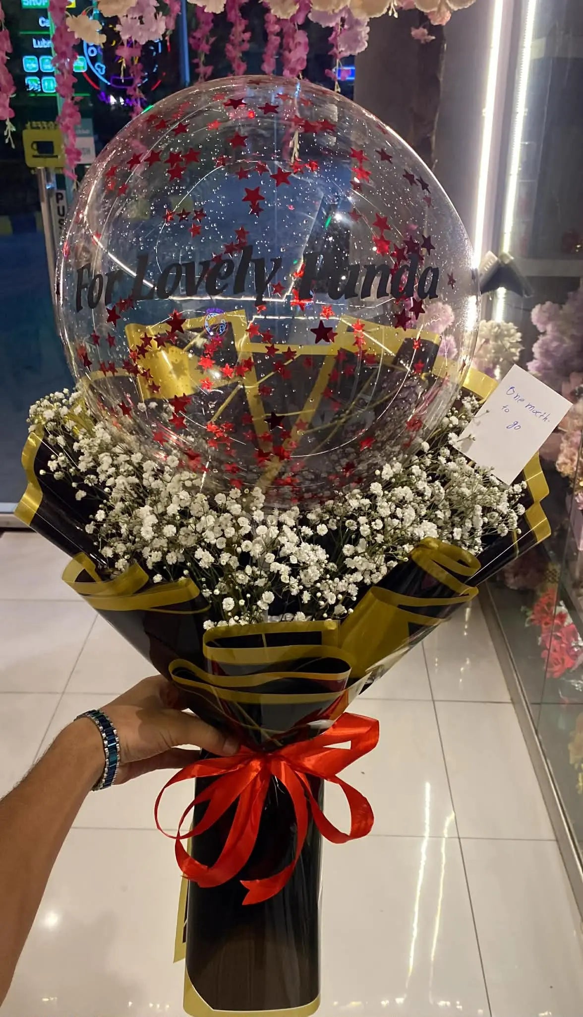 Baby’s breath flower bouquet paired with a custom message balloon.