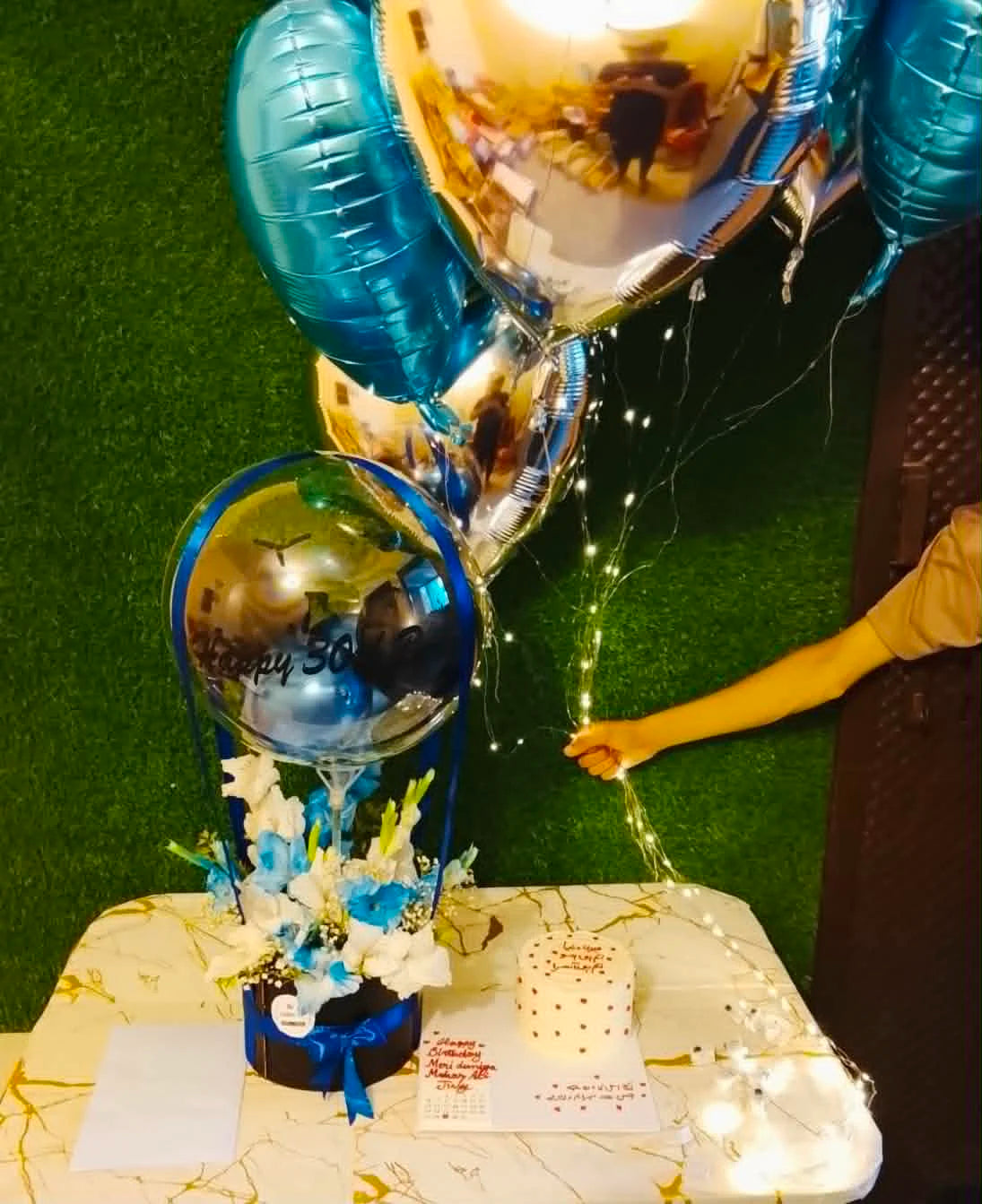 Personalized birthday gift for him with blue and white balloon box, flowers, LED helium foil balloons, 2 lbs cake and birthday month calendar in Islamabad.
