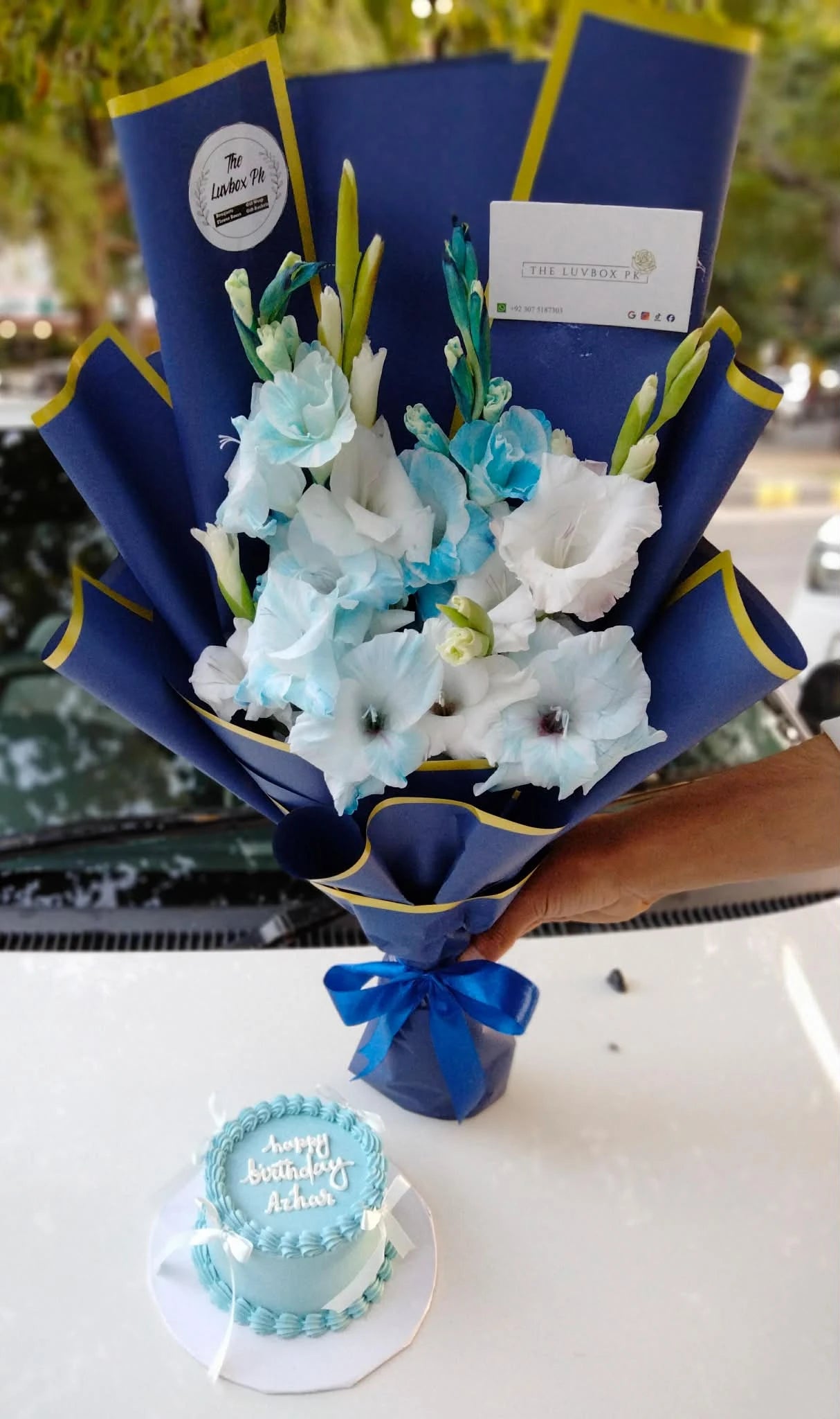 Blue and white gladiolus bouquet with light blue bento cake for him from gift shop Islamabad
