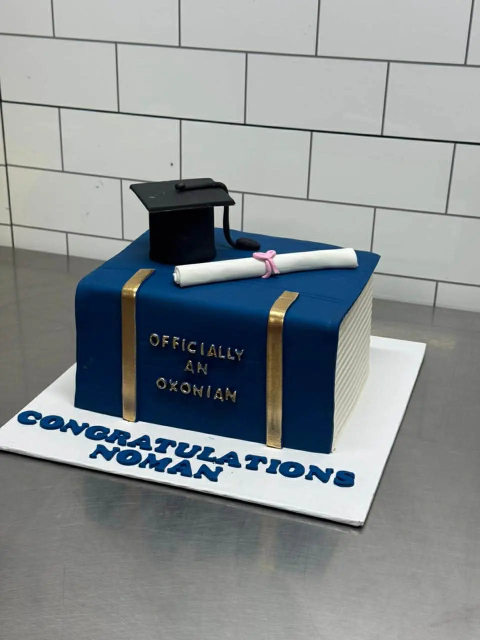 Blue themed 8 lbs customized graduation cake for him, perfect for promotions and celebrations.