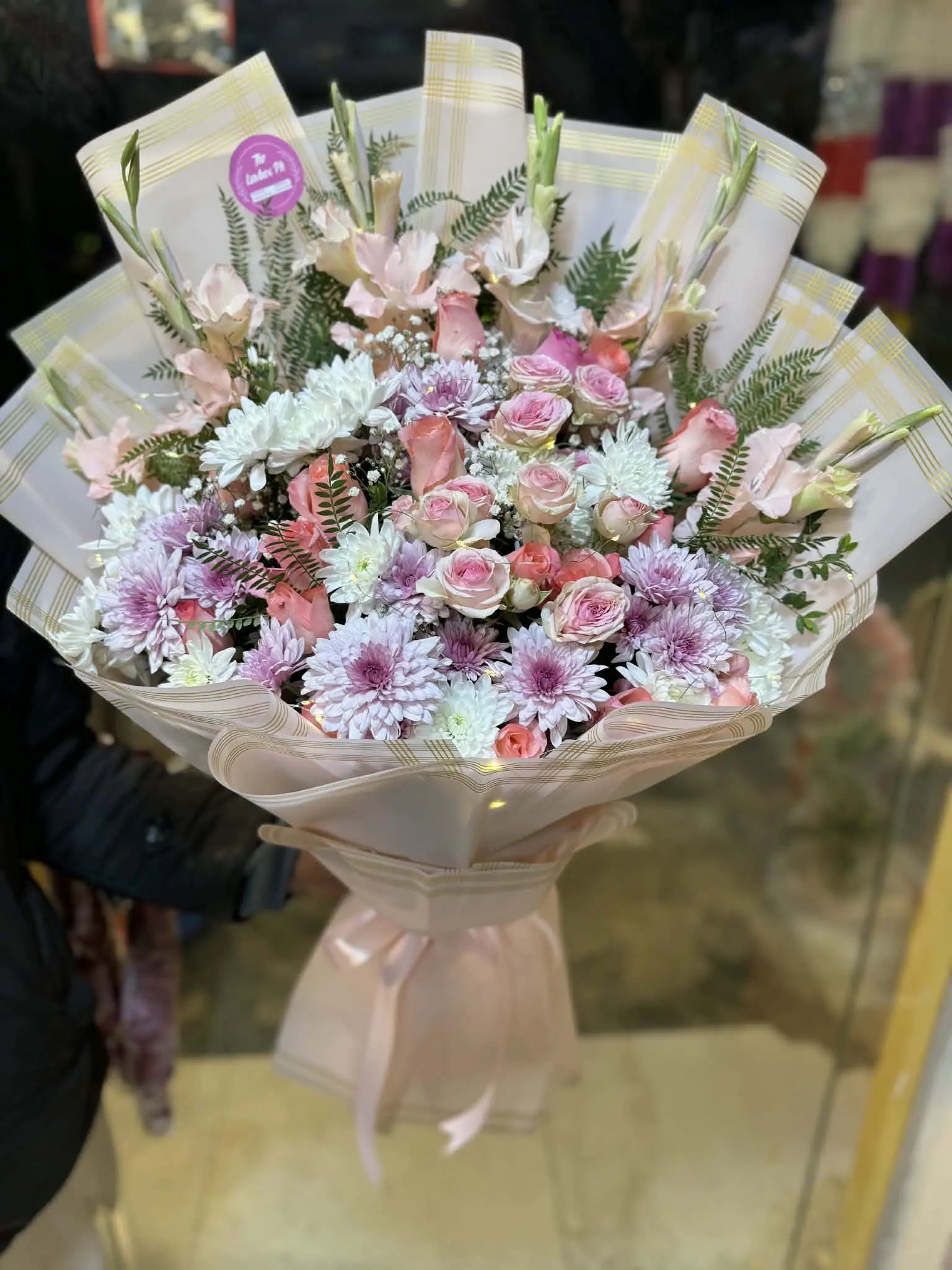 Oversized pink floral bouquet with LED lights, wrapped luxuriously for gifting.