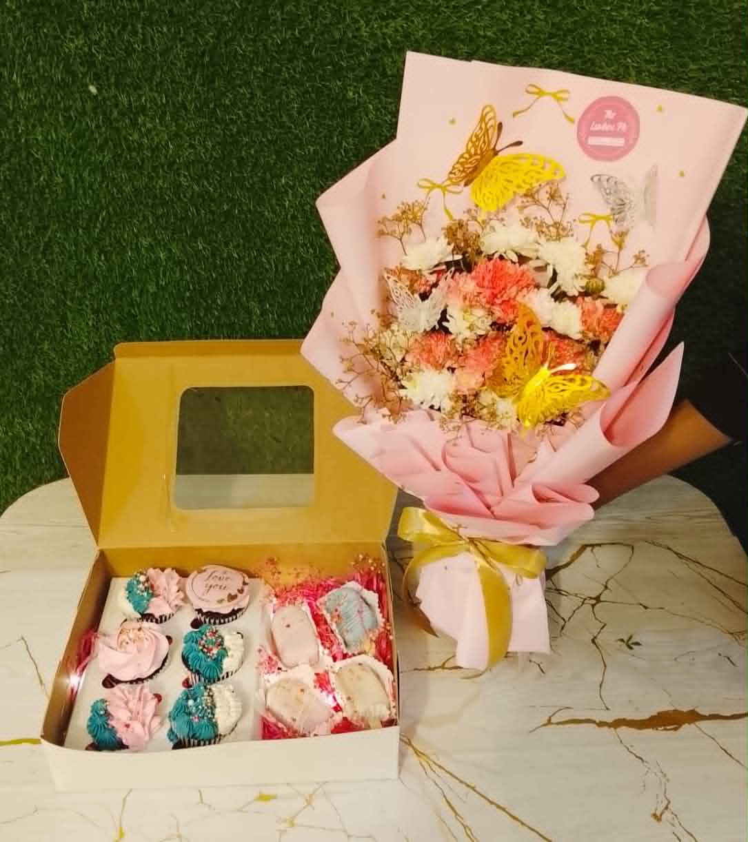 Luxury pink and white floral gift box with fresh flowers, designer cupcakes, and cake-sicles for birthdays and special occasions in Pakistan.