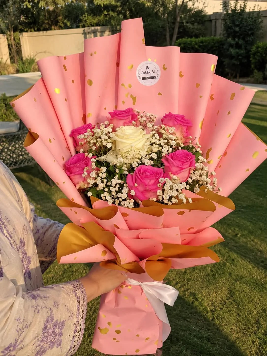 Budget-friendly imported pink rose bouquet with one elegant white rose in the center, beautifully wrapped as a romantic flower gift for her