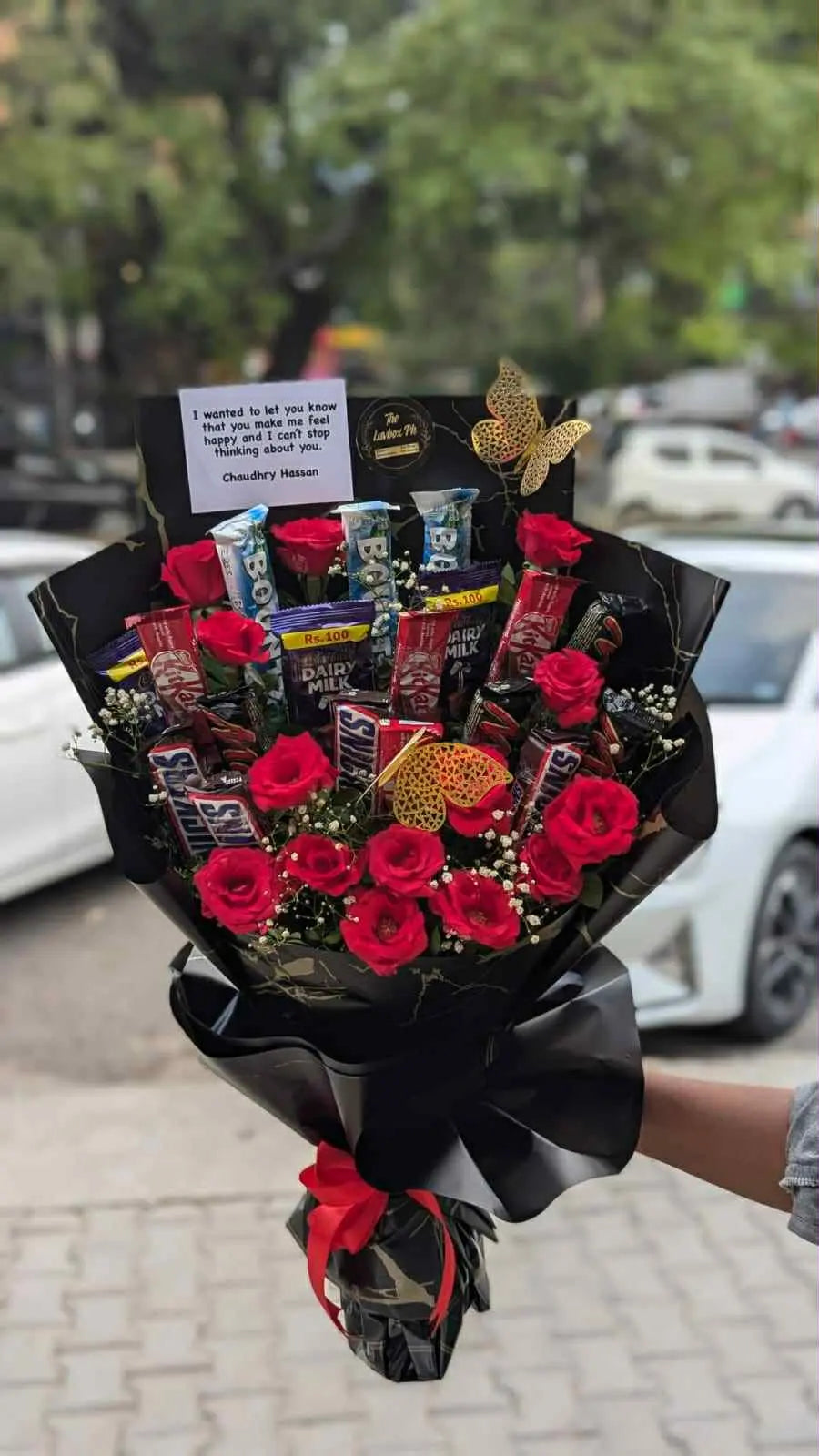 Luxury bouquet with red roses and chocolates wrapped elegantly