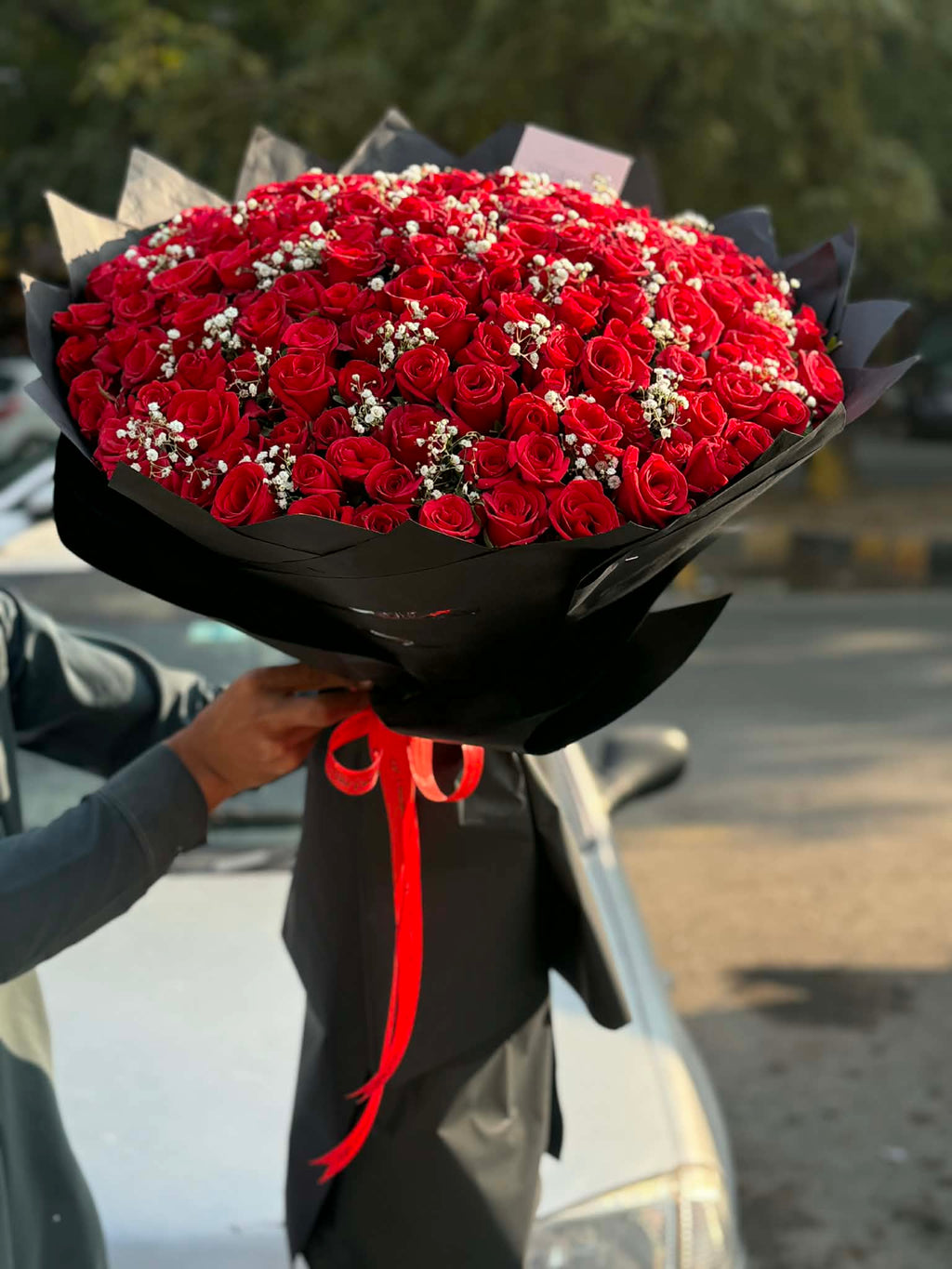 Oversized luxury red rose bouquet with 150–200 long-stem roses beautifully wrapped.
