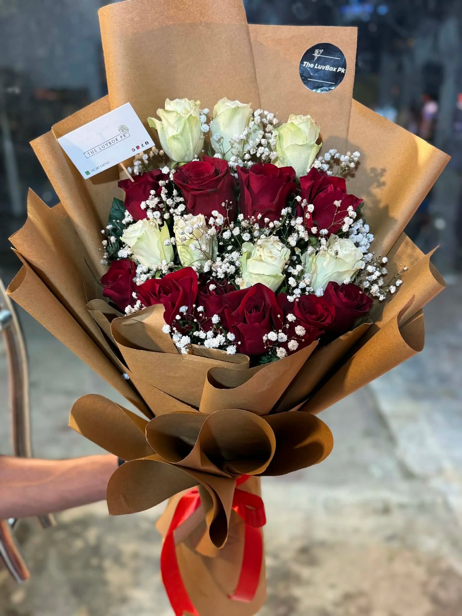 White and red rose flower bouquet elegantly packed from gift shop Islamabad
