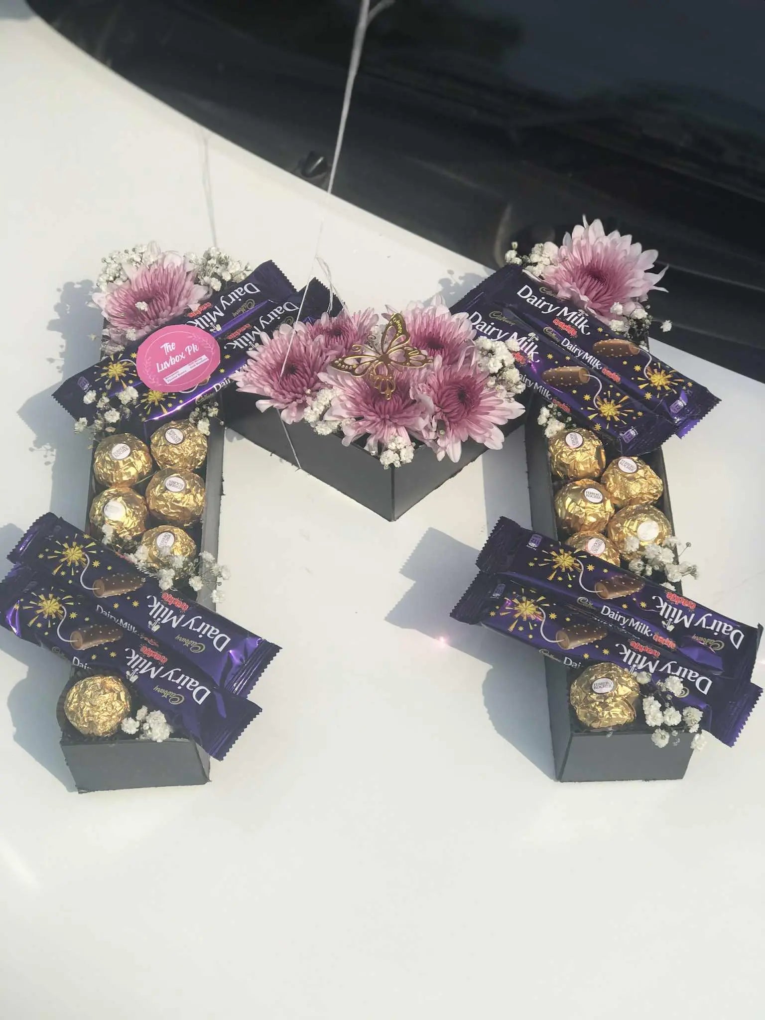 Custom letter arrangement with fresh flowers and chocolates, personalized alphabet gift in Pakistan.