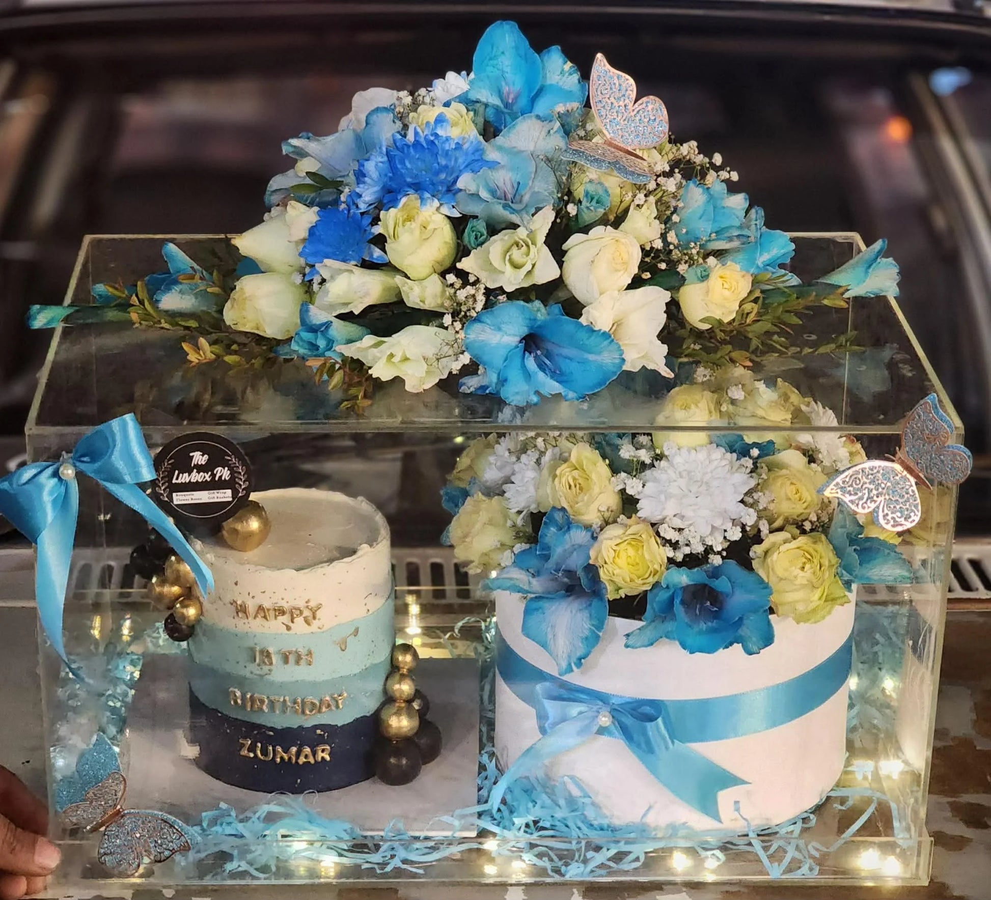 Luxury Father’s Day acrylic box with cake and blue white flower arrangement.