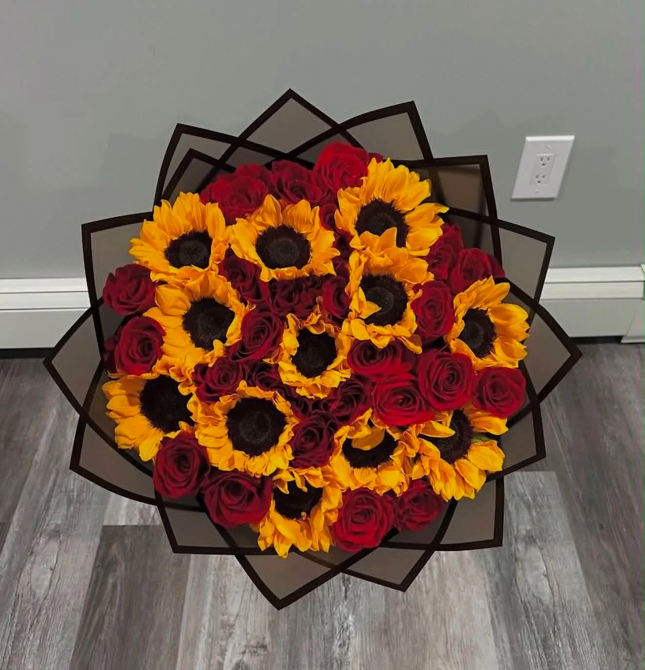 Oversized anniversary bouquet featuring fresh red roses and bright sunflowers, beautifully arranged as a romantic luxury flower gift in Islamabad.