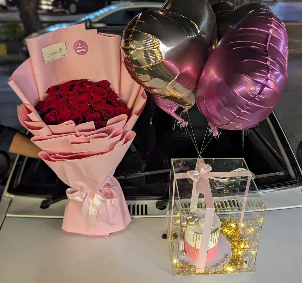 Luxury 50 rose bouquet with cake in acrylic box and balloons from gift shop Islamabad
