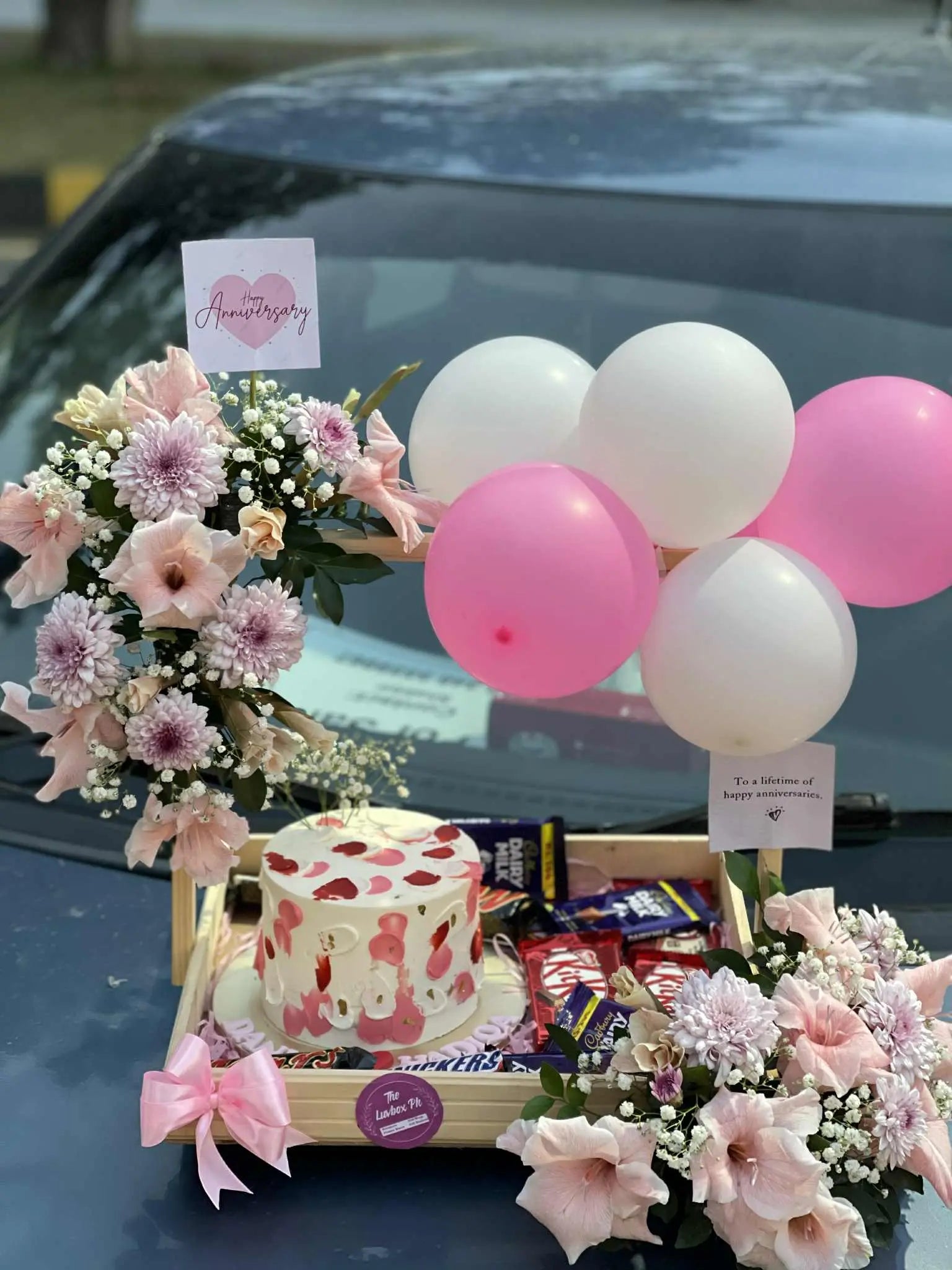 Gorgeous birthday wooden basket with flowers, 2 lbs customized cake & chocolates – luxury birthday gift in Pakistan.