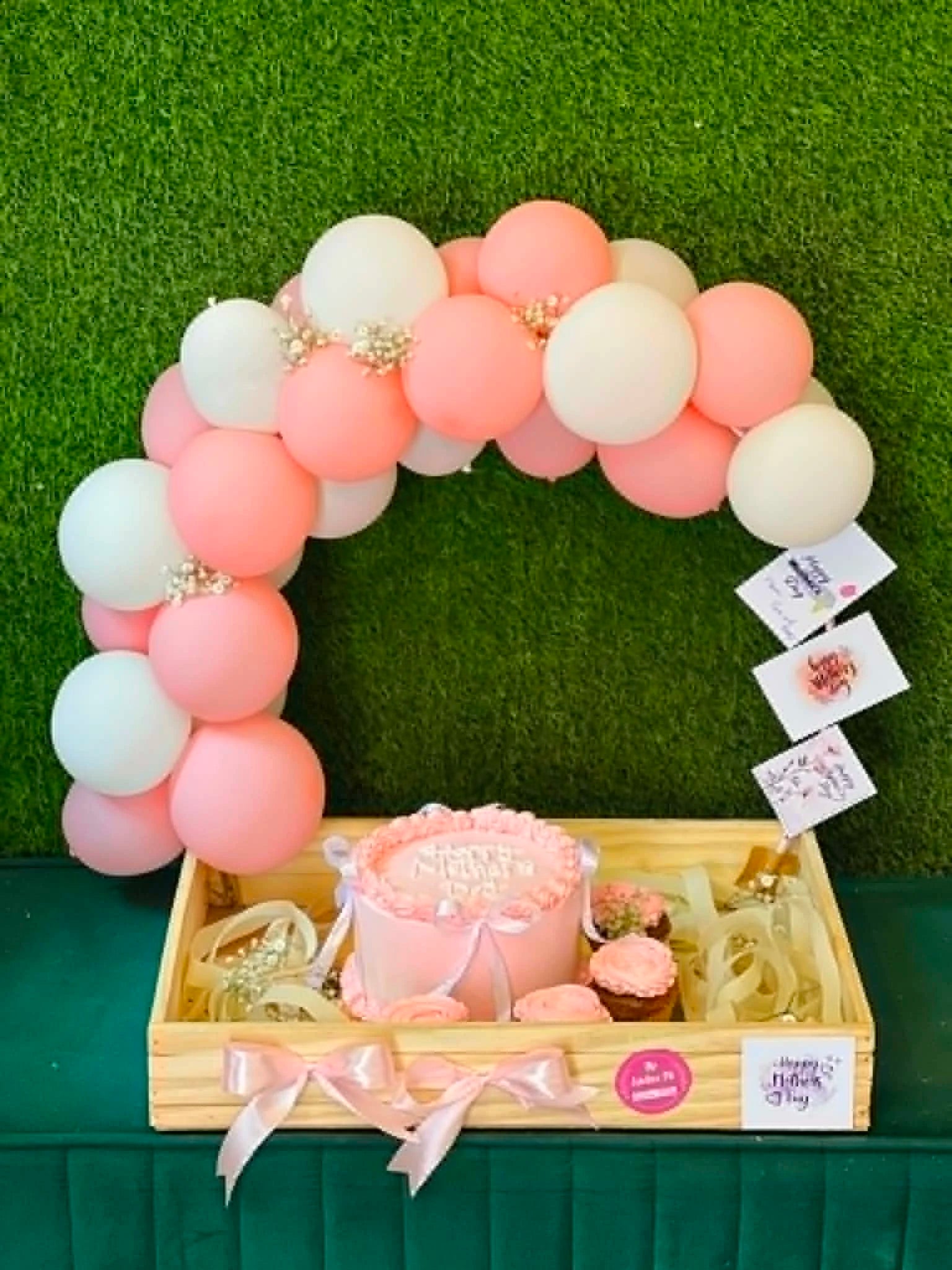 Luxury birthday wooden tray with 2 lbs cake, cupcakes, personalized photos, and balloon arch for birthday gift delivery in Pakistan.