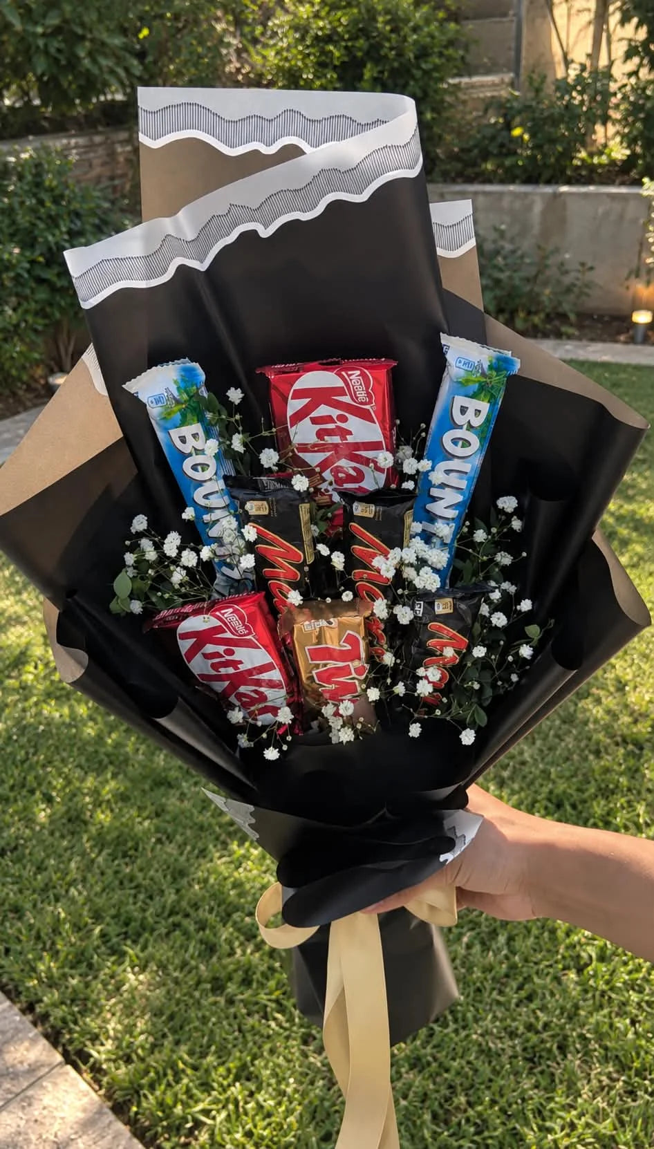 Elegant chocolate bouquet with assorted chocolates, delicate white baby's breath flowers and premium black wrapping for all occasions in Pakistan