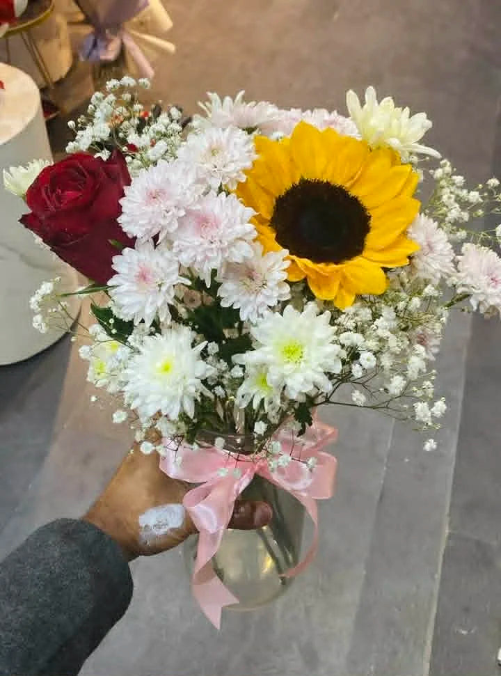 Mixed flower arrangement in glass vase for Mother’s Day gifting.