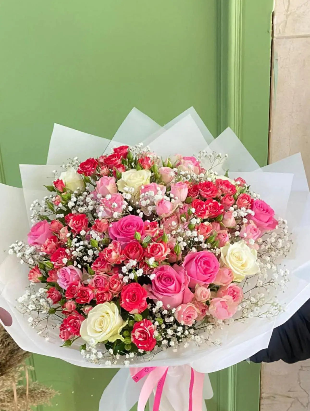 Oversized floral bouquet with roses and spray roses wrapped elegantly for flower delivery in Islamabad.