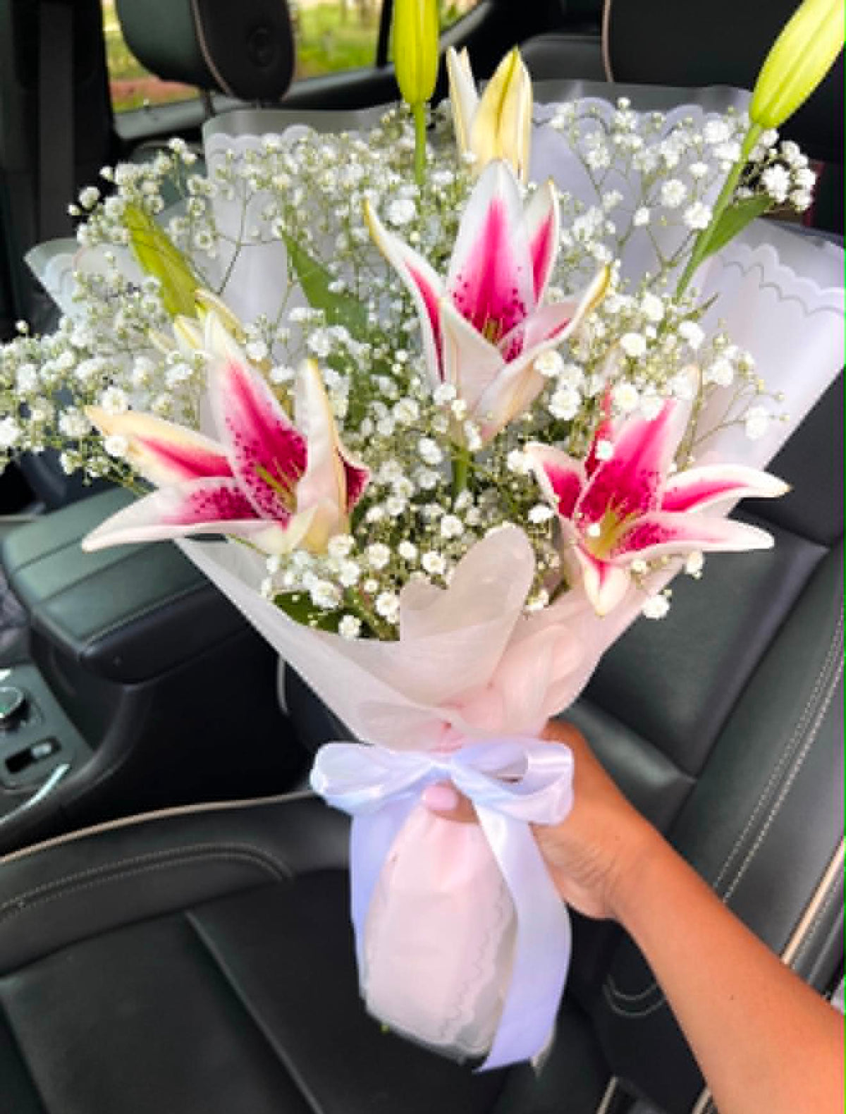 Gorgeous bouquet of three pink lilies, beautifully arranged and elegantly wrapped for flower delivery in Islamabad.