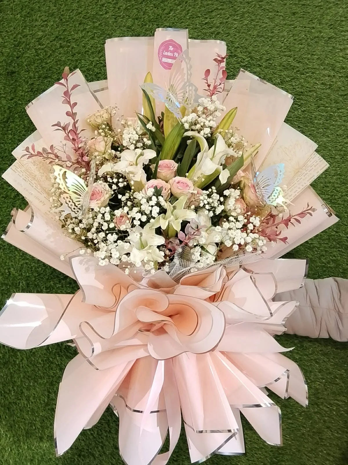 Gorgeous bouquet with pink roses and white or pink lilies for elegant flower gifting.