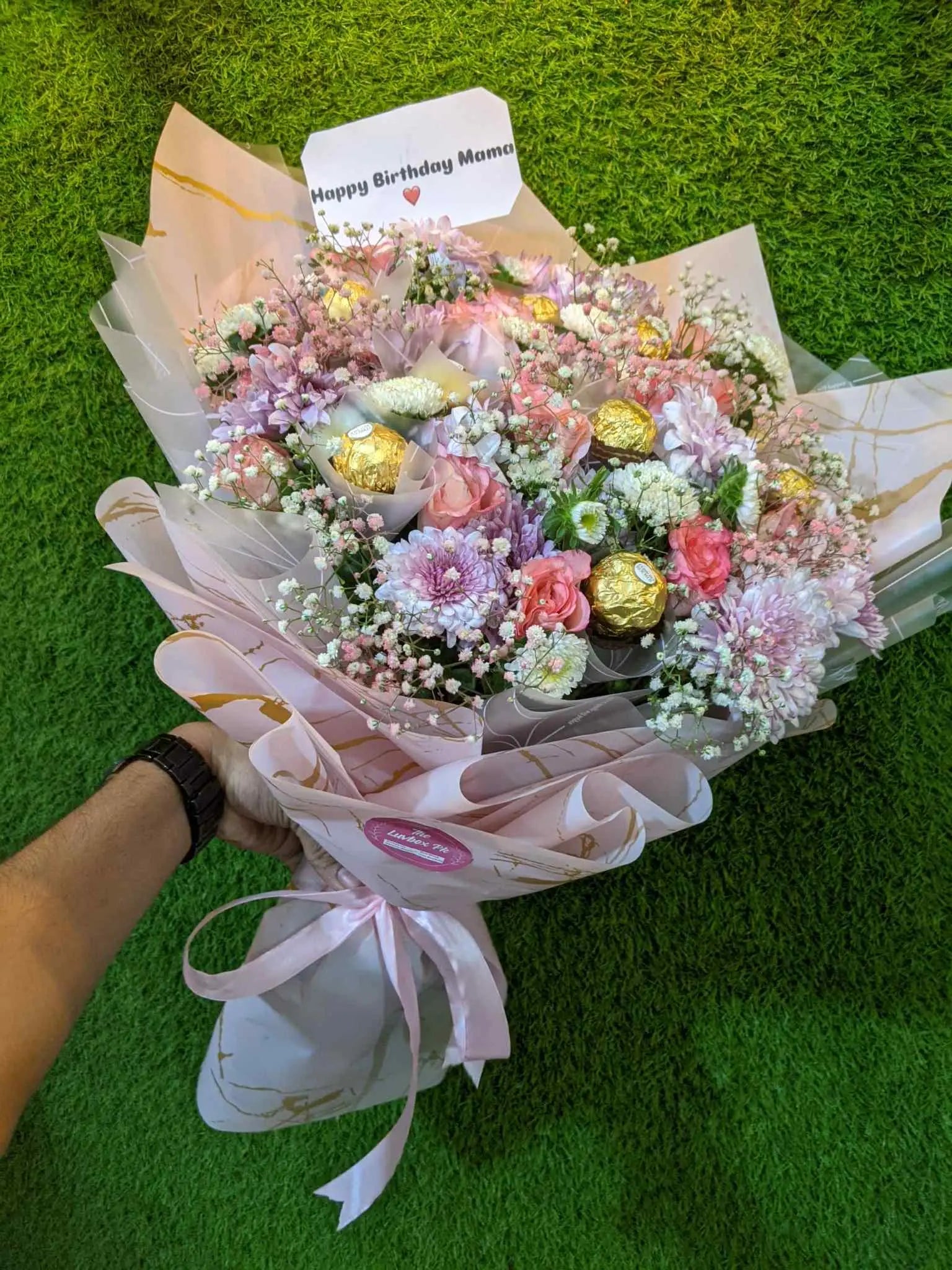 Pretty pink flower bouquet with Ferrero Rocher chocolates wrapped elegantly
