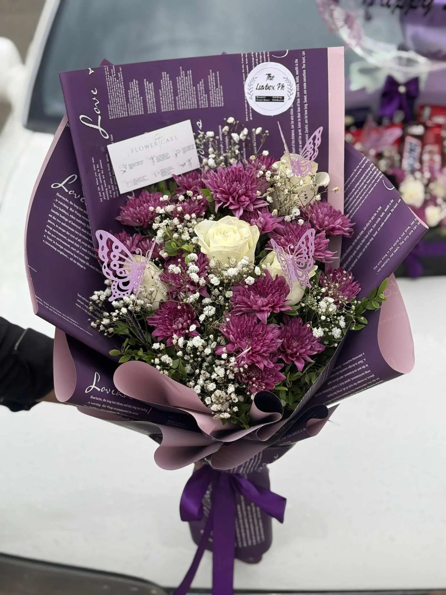 Elegant purple themed flower bouquet wrapped beautifully