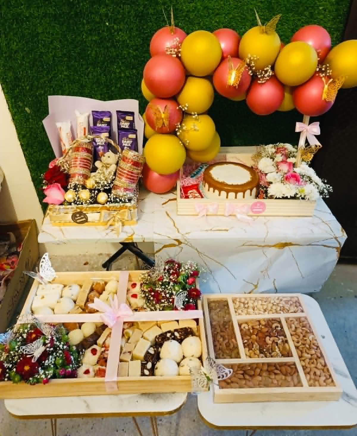 Luxury wedding gift combo with large mithai tray, dry fruits, cake, flowers, balloons, bangles and chocolates beautifully arranged in premium trays and baskets.
