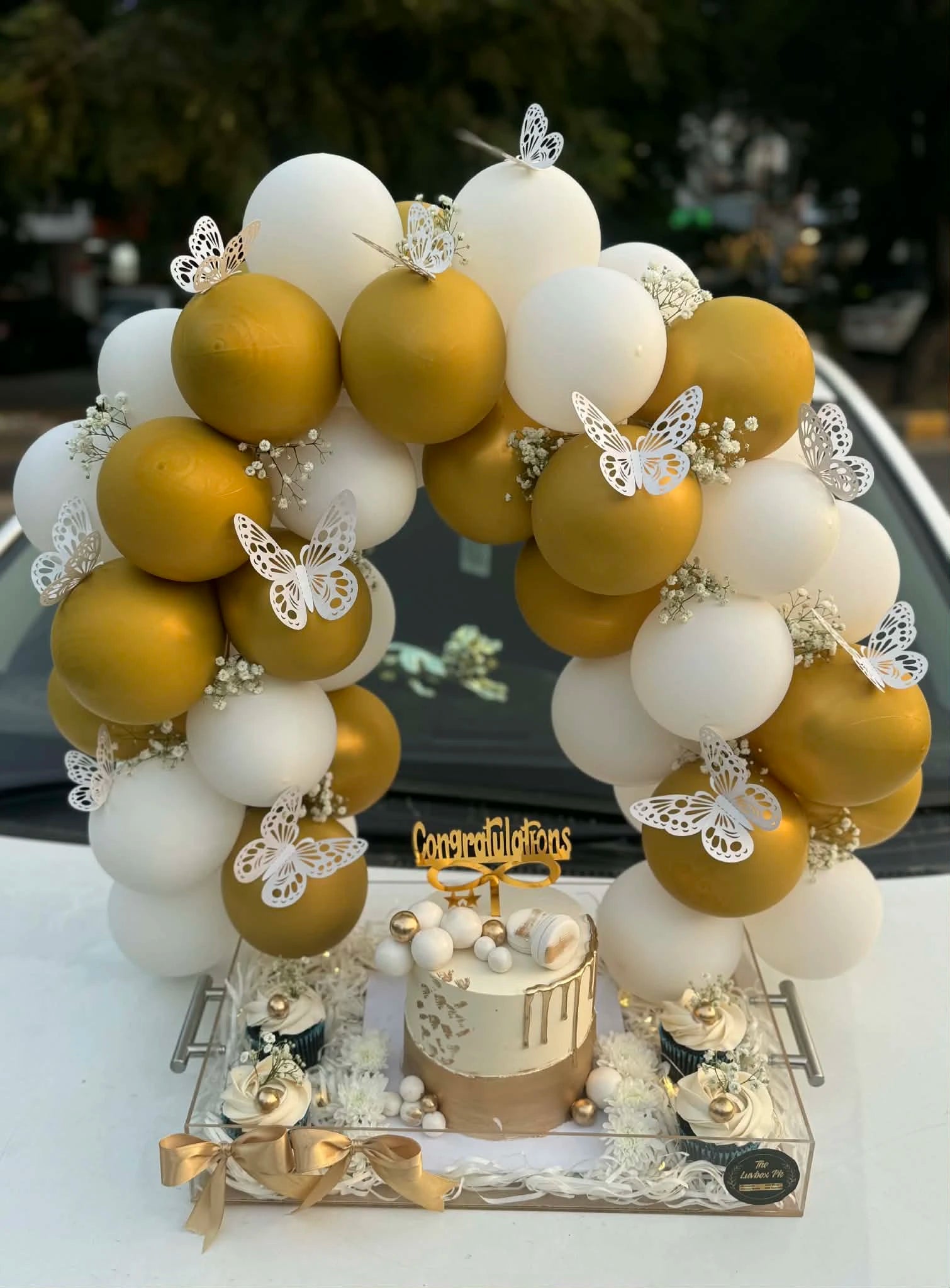 Signature new home luxury celebration tray with balloon arch acrylic tray cake and cupcakes from gift shop Islamabad
