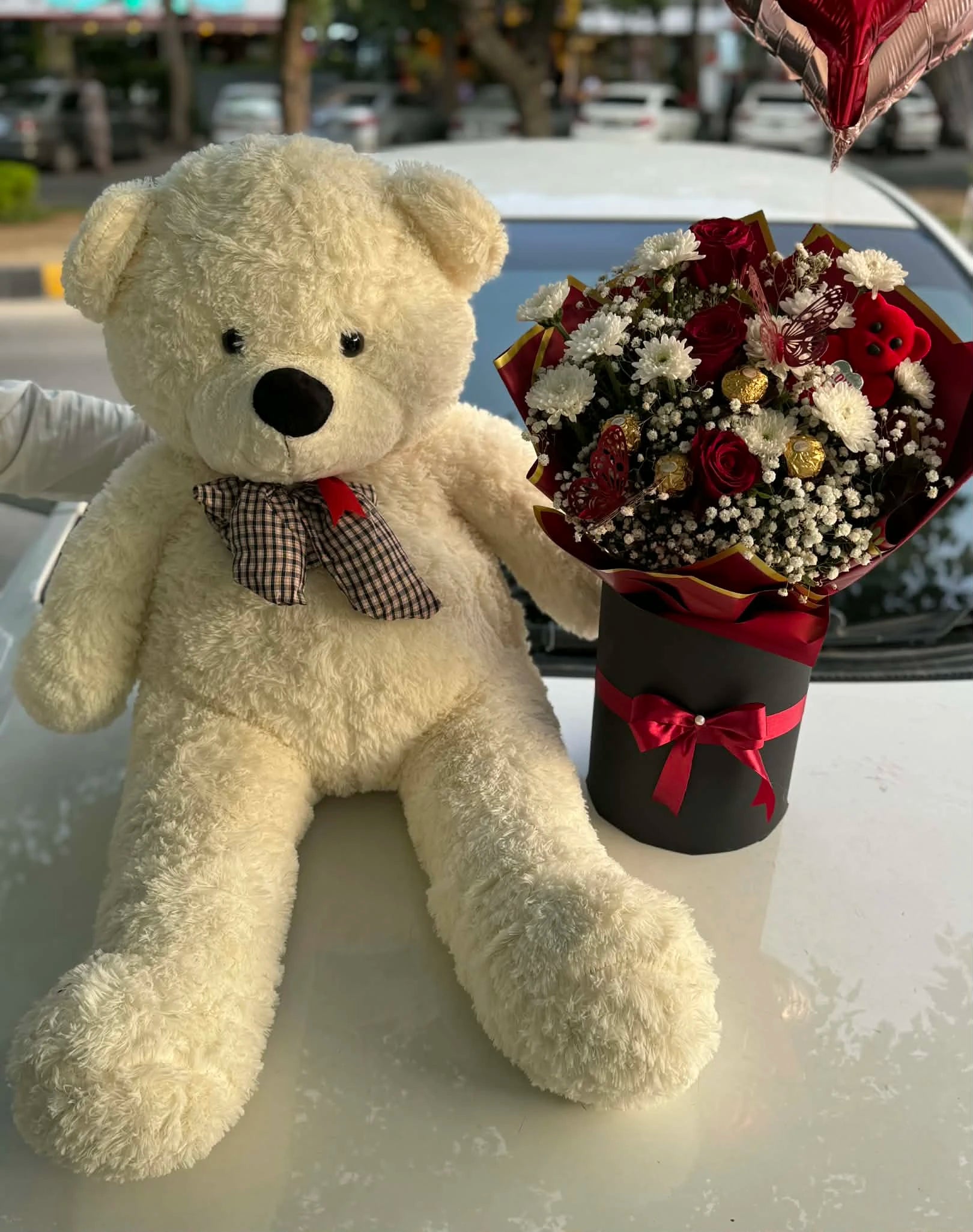 White teddy bear with ferrero flower bouquet box from gift shop Islamabad
