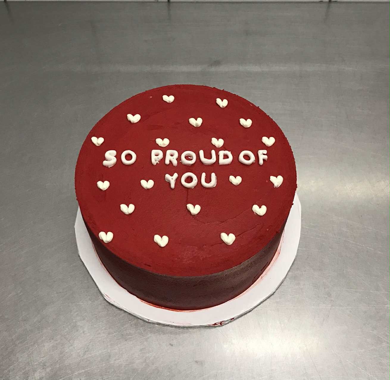 So Proud of You 2 lbs red-themed graduation cake for children – perfect celebration gift in Pakistan.