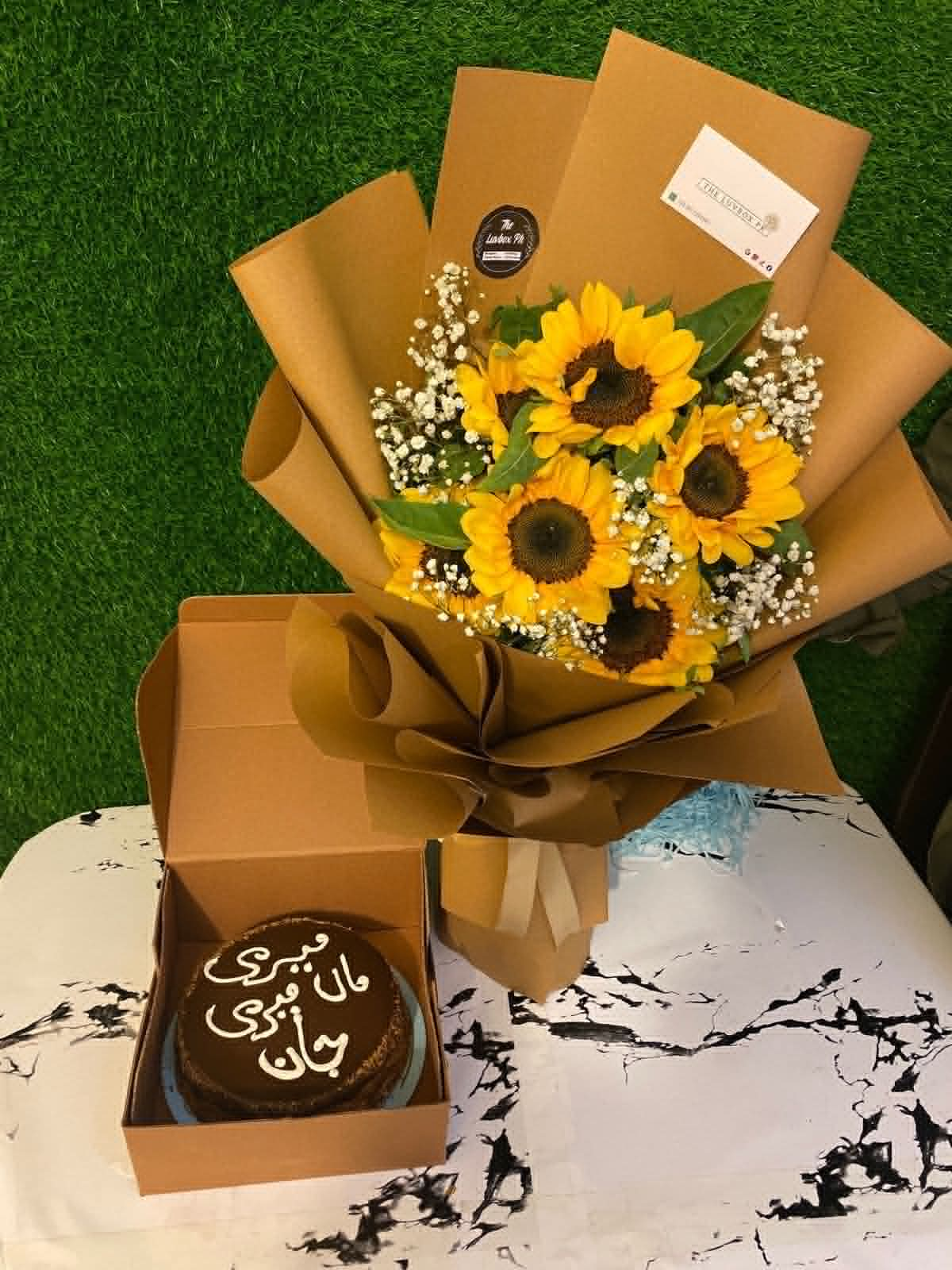 Affordable birthday combo for mom with a 2.5 lbs layered cake and mini sunflower bouquet, beautifully presented for birthday gift delivery in Pakistan.