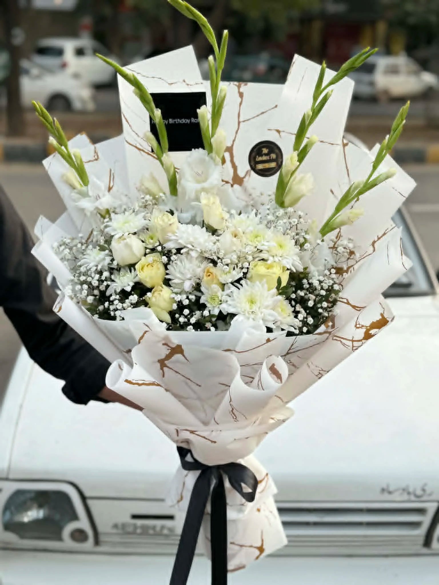 Elegant white bouquet with gladiolus, chrysanthemums and white roses.