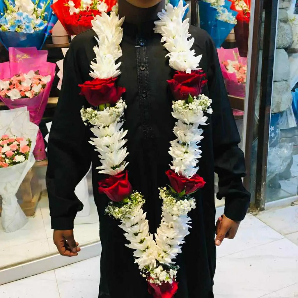 White and red themed luxury groom’s flower garland for weddings